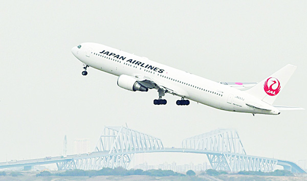 A Japan Airlines passenger plane takes off from Tokyo’s Haneda airport on Oct 30. Japan Airlines (JAL) said on Oct 30 its six-month net profit soared nearly 29 percent while the carrier boosted its full-year forecasts thanks to a surge in tourism and a steep slide in fuel costs. (AFP)
