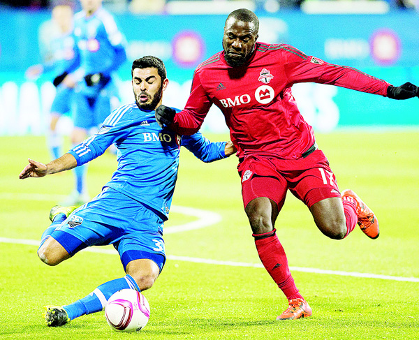 Montreal Impact’s Victor Cabrera (left), is challenged by Toronto FC’s Jozy Altidore during second-half MLS soccer playoff action in Montreal on Oct 29. (AP)