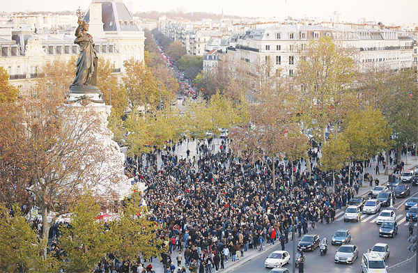 People gather around the Monument a la Republique at the Place de la Republique in Paris,