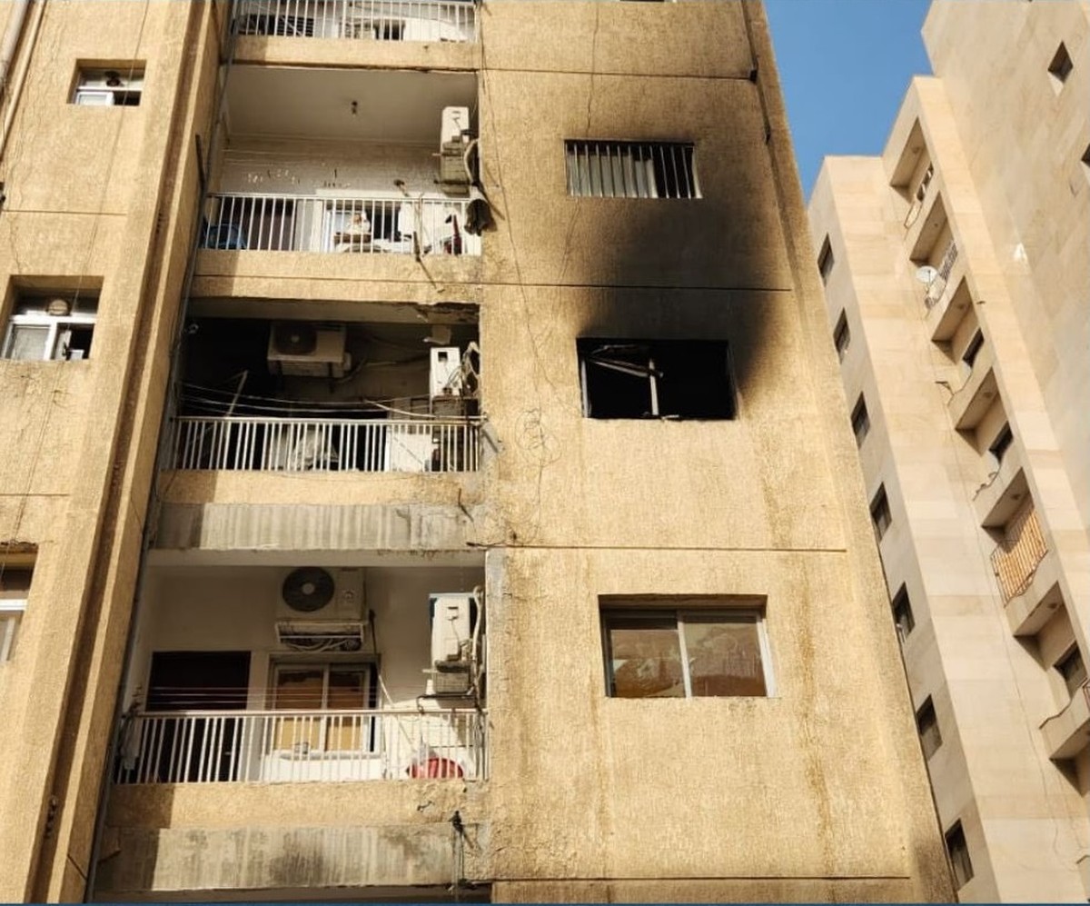 Firefighters contain a blaze in an apartment building in Hawalli