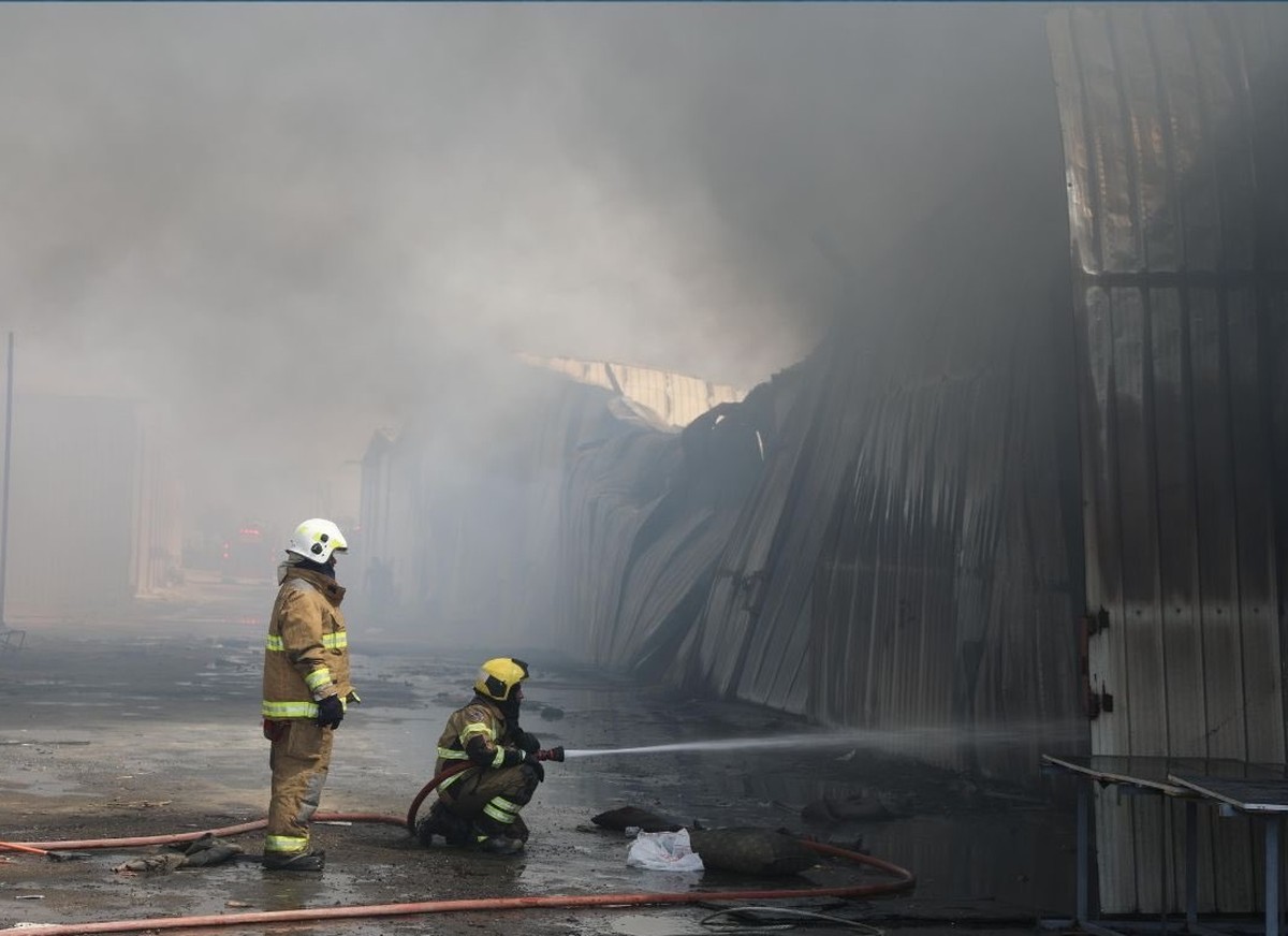 Firefighters contain a major blaze at a warehouse in the Sulaibiya area