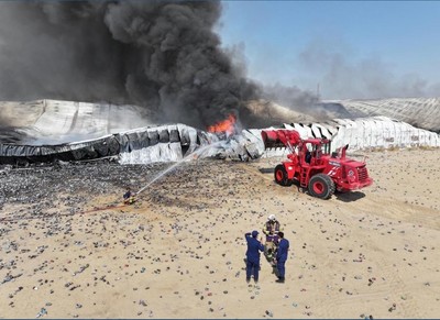 Firefighters contain a major blaze at a warehouse in the Sulaibiya area ...
