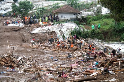 Indonesian rescuers struggle with mud, debris in search for dozens missing after landslide