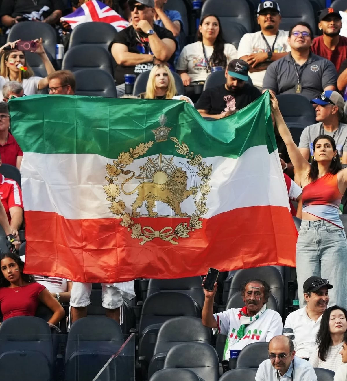 Lion and Sun Flag and Protest Banner Draw Attention During Iran-New Zealand World Cup Match in Los Angeles