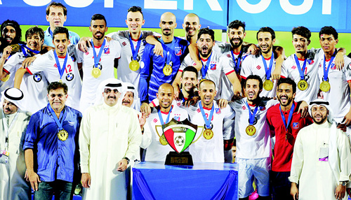 Super Cup champions Kuwait SC celebrate on the podium with officials. Super Cup champions Kuwait SC celebrate on the podium with officials.