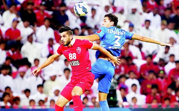 Majed Hassan (left), of UAE’s Al-Ahli fights for the ball against Carlos Eduardo of Saudi’s Al-Hilal during their AFC Champions League semifinal football match on Oct 20, in Dubai. (AFP)