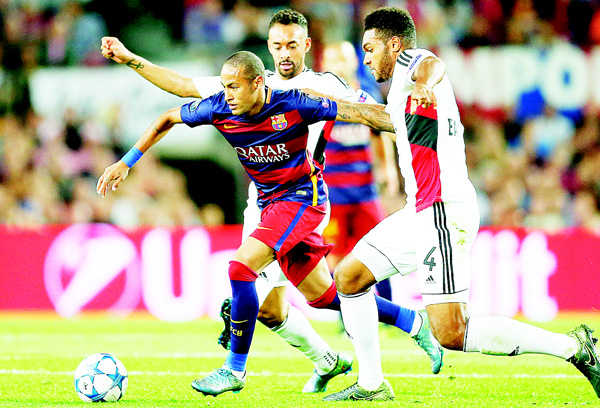 In this file photo, Barcelona’s Neymar (center), vie for the ball with Leverkusen’s Jonathan Tah (right), during a Champions League Group E soccer match between Barcelona and Bayer Leverkusen at the Camp Nou Stadium in Barcelona, Spain on July 20, 2015. (AP)