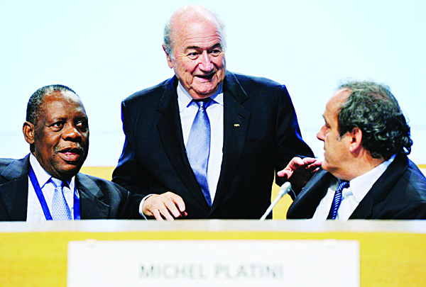 In this May 25, 2012 file photo FIFA President Joseph Blatter (center), chats with Confederation of African Football (CAF), President Issa Hayatou (left), and UEFA President Michel Platini during the second day session of the 62nd FIFA Congress in Budapest, Hungary. (AP)