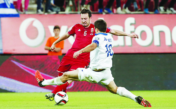 Hungary’s Akos Elek (left), is challenged by Greece’s Sokratis Papastathopoulos during the Group F Euro 2016 qualifying match between Greece and Hungary at the Georgios Karaiskakis Stadium in Piraeus post, near Athens on Oct 11. (AP)