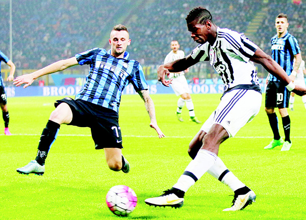Juventus’ Paul Pogba (right), kicks the ball past Inter Milan’s Marcelo Brozovic during a Serie A soccer match between Inter Milan and Juventus at the San Siro Stadium in Milan, Italy on Oct 18. (AP)