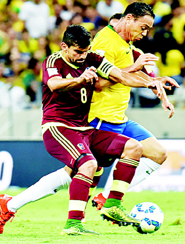 Brazil’s Ricardo Oliveira (right), is marked by Venezuela’s Tomas Rincon during their Russia 2018 FIFA World Cup South American Qualifiers match, at the Estadio Castelao Stadium in Fortaleza, Brazil on Oct 13. (AFP)