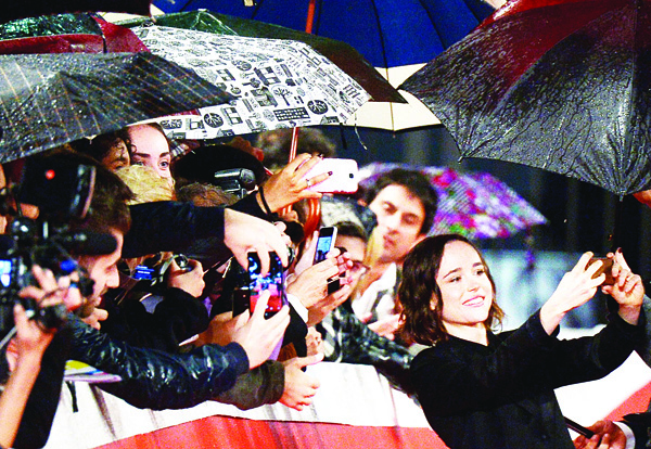Canadian actress Ellen Page (right), snaps a selfie with fans on the red carpet before the screening of the movie ‘Freeheld’ at the 10th Rome Film Festival on Oct 18, in Rome. (AFP)