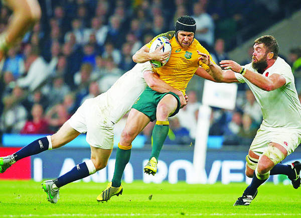 Australia’s Matt Giteau (center), is tackled during the Rugby World Cup Pool A match between England and Australia at Twickenham stadium in London, Oct 3. (AP)
