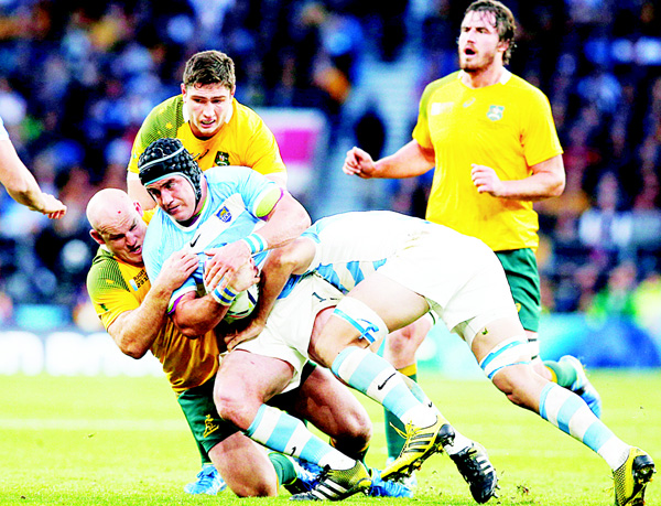 Argentina’s Marcos Ayerza is tackled by Australia’s Stephen Moore during their Rugby World Cup semifinal match at Twickenham Stadium London, on Oct 25. (AP)