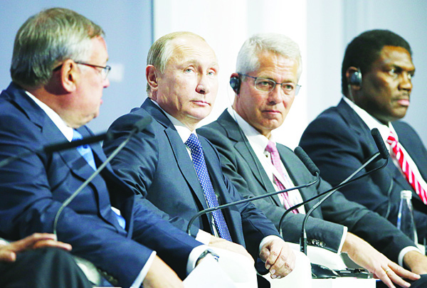Russian President Vladimir Putin (second left), attends the 7th annual VTB Capital ‘Russia Calling!’ Investment Forum in Moscow, Russia. S&P says the outlook for Russia’s recession-hit economy remains weak as it struggles with sanctions and lower oil prices. (AP)