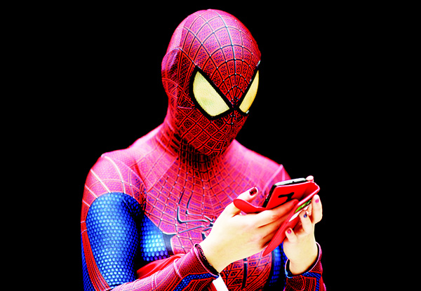 A woman dressed as Spiderman uses her mobile phone at the MCN Comic Con in east London, on Oct 23. The event is the largest of its type in the UK and sees fans and enthusiasts flock to the ExCel Centre to meet their heroes, browse merchandise and see previews of upcoming releases. (AFP)