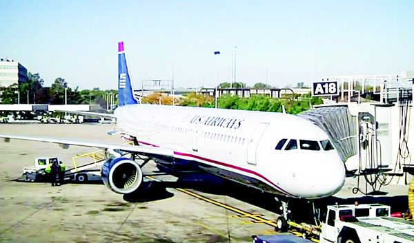 In this image taken from video, US Airways flight 1939, the final US Airways flight, prepares to depart Philadelphia International Airport for Charlotte, NC on Oct 16. All future flights will fly under the American Airlines banner, following the completion of a merger announced in 2013. (AP)