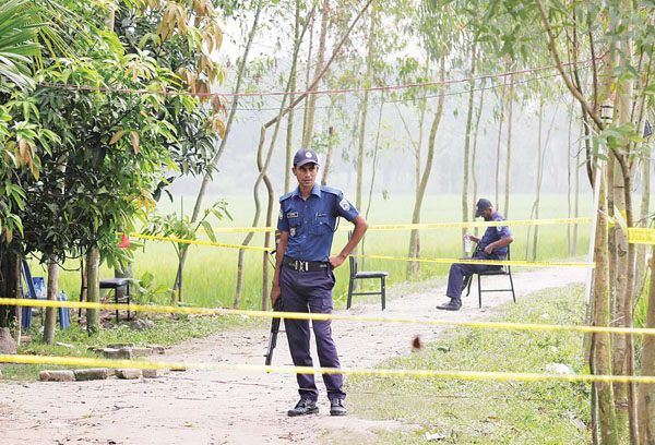 Bangladeshi security officers stand by the site where a Japanese Kunio Hoshi was killed at Mahiganj village in Rangpur district, 300 kms (185 miles) north of Dhaka