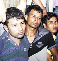 This photo taken on Oct 5, shows Mohammad Javed (left), an explosives expert with the Islamist group Jamayetul Mujahideen Bangladesh (JMB), being presented to the media following his arrest in Chittagong. (AFP)