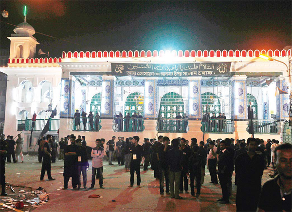 Bangladeshi Shiite Muslims stand at the site of an explosion in Dhaka, Bangladesh on Oct 24. (AP)