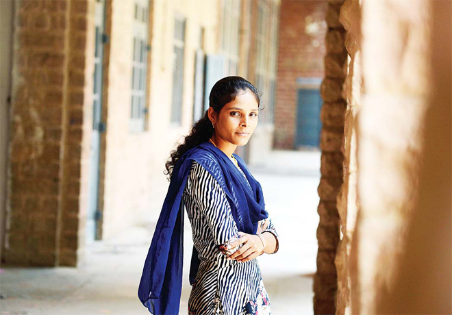 20-year-old Indian student Santa Devi Meghwal poses at her college in Jodhpur. Meghwal was only 11-months-old when her elders married her to a nineyear- old boy from a neighbouring village in the desert state of Rajasthan, where rates of child marriages have long been high. (AFP)