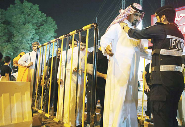 Kuwaiti security check Kuwaiti Shiite Muslims as they arrive to attend an Ashura commemoration, which marks the seventh century slaying of Imam Hussein, the grandson of Prophet Muhammad (PBUH) and one of Shiite Islam’s most revered figures, in Kuwait City, on Oct 23. (AFP)