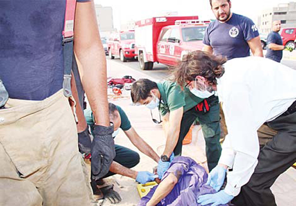 Fire dept personnel pull out the unconscious person from the manhole
