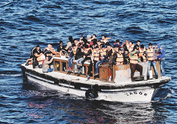 Refugees and migrants arrive on the Greek island of Lesbos after crossing the Aegean sea from Turkey on Oct 26.