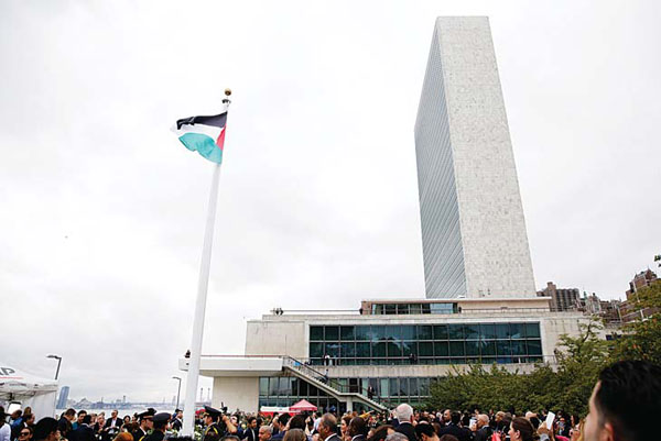The State of Palestine flag files for the first time at the UN headquarters in New York, on Sept 30. (AFP)