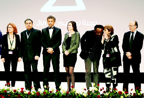 President of the jury of the 26th Carthage Film Festival, Morocco’s Noureddine Sail (right), stands next to (from right to left) jury members Palestine’s Leila Shahid, Nigeria’s Newton Aduaka, Chile’s Marcela Said, Egypt’s Oussama Fawzi, French Tunisian Abel Jafri and Tunisia’s Anissa Barrak during the opening ceremony on Nov 21, in the Tunisian capital Tunis. (AFP)