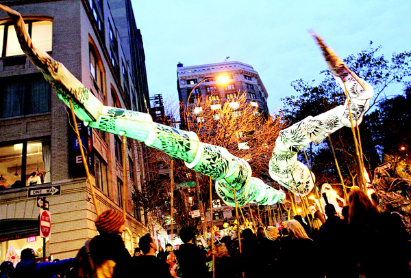 People holding snake puppets wait for the start of the Greenwich Village Halloween Parade on Oct 31, in New York. (AP)