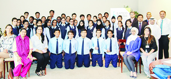 A group picture of Carmel School students and KAMCO representatives.
