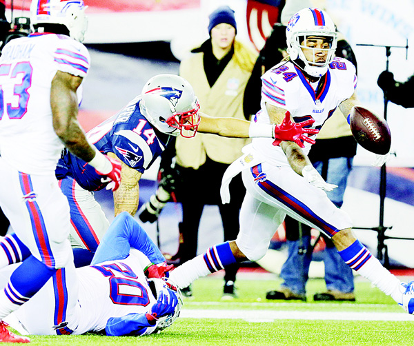 Buffalo Bills defensive back Stephon Gilmore (24) intercepts a pass intended for New England Patriots wide receiver Chris Harper (14) in the second half of an NFL football game, on Nov 23, in Foxborough, Mass. (AP)