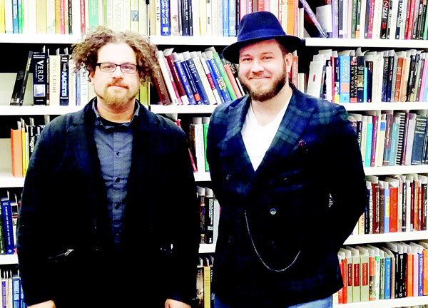 Composer David T. Little (left), and librettist Royce Vavrek pose for a picture in the library of the National Opera Center in New York on Nov 18. (AFP)
