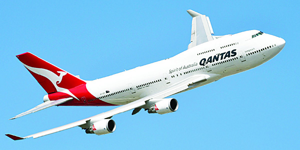 A file photo taken on March 15 show a Qantas Boeing 747 in the skies above Melbourne. Australian carrier Qantas on Nov 17, got shot of its ‘junk’ status when Standard & Poor’s lifted its rating from ‘BB+’ to the prized investment grade ‘BBB-’ as the airline bounces back from a tough few years. The upgrade of Qantas’ long-term corporate credit and issue rating comes after the airline completed a profit turnaround this year, supported by lower fuel prices, and adopted a more conservative financial framework. (AFP)