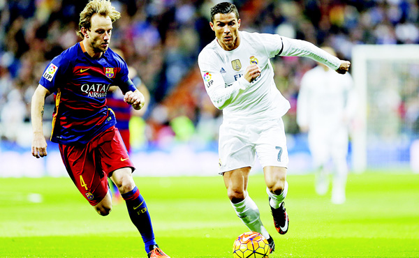 Real Madrid’s Cristiano Ronaldo fights for the ball with Barcelona’s Ivan Rakitic during the first clasico of the season between Real Madrid and Barcelona at the Santiago Bernabeu stadium in Madrid, Spain, on Nov 21. (AP)