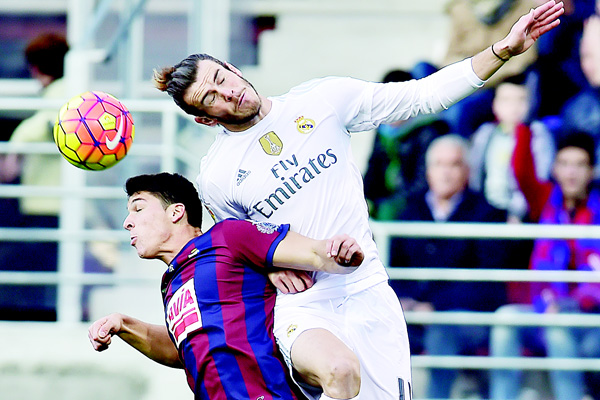 Real Madrid’s Gareth Bale (right), jumps for the ball with SD Eibar’s Ander Capa, during their Spanish La Liga soccer match, at Ipurua Stadium in Eibar, northern Spain on Nov 29. (AP)