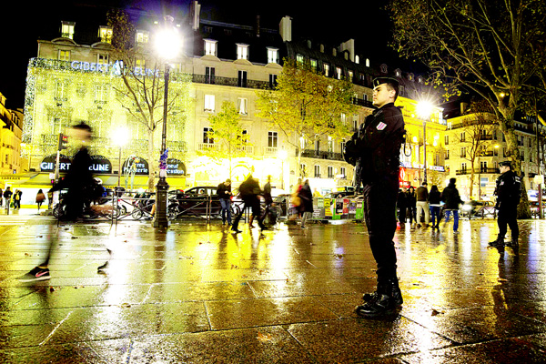 French gendarms (right), enforcing the Vigipirate plan, France’s national security alert system, are pictured on Nov 19, on Place Saint-Michel in Paris. France revealed on Nov 19 it will spend an extra 600 million euros ($641 million) next year to ramp up security after the Paris attacks. President Francois Hollande announced this week that France is freezing plans to cut troop numbers through 2019. At the same time, the country will add 8,500 law enforcement jobs including 5,000 new police. (AFP)