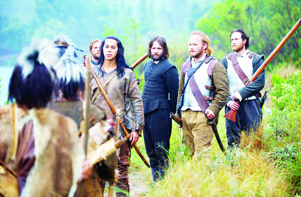 This image released by National Geographic shows a scene from ‘Saints & Strangers,’ premiering Nov 22-23 at 9 pm ET. The four-hour movie tells the story of religious pilgrims and thrill-seeking opportunists thrown together on the Mayflower, and their efforts to build a settlement peacefully among the Native Americans they encounter.