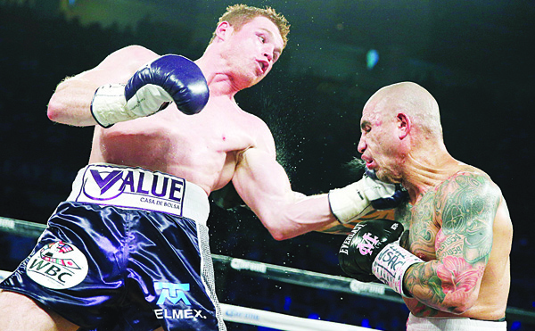 Miguel Cotto (right), of Puerto Rico, gets hit by Canelo Alvarez of Mexico, during a WBC middleweight title bout on Nov 21 in Las Vegas. (AP)