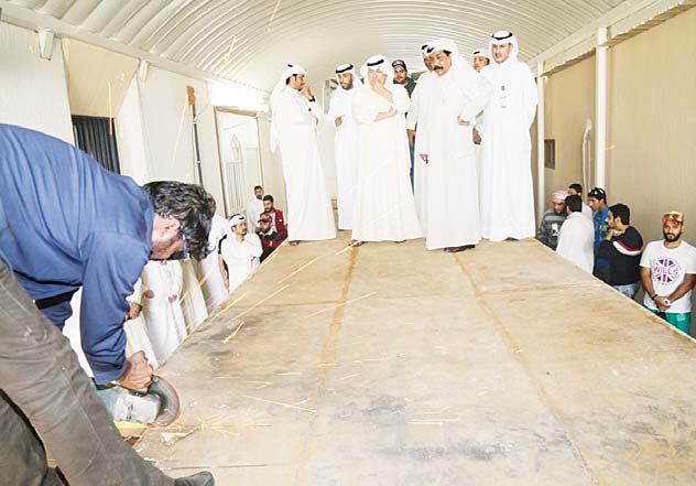 Lt-Gen Sulaiman Al-Fahad, Major General Abdulhameed Al-Awadhi and other senior officials look on as Customs men open up the container packed with hashish and drug pills.