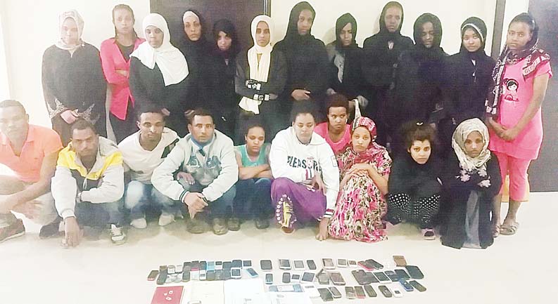 Some of the 22 ‘runaway’ domestic workers with the gang leaders.