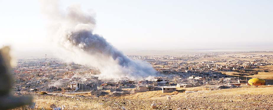 Smoke believed to be from an airstrike billows over the northern Iraqi town of Sinjar on Nov 12. Kurdish Iraqi fighters, backed by the US-led air campaign, launched an assault Thursday aiming to retake the strategic town of Sinjar, which the Islamic State overran last year in an onslaught that caused the flight of tens of thousands of Yazidis and first prompted the US to launch airstrikes against the militants. (AP)