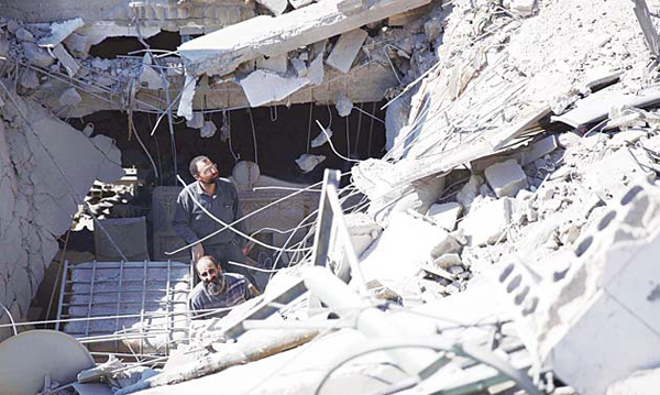 Syrian men check the destruction following a reported airstrike by Syrian government forces in the rebel-held town of Douma, on the eastern edges of the capital Damascus, on Nov 1. (AFP)