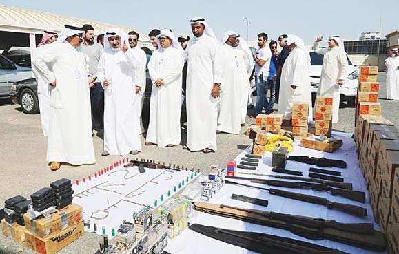 Securitymen and CID officials inspecting the seized weapons in the farm.
