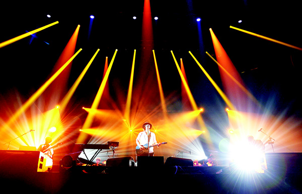 This photo taken on Nov 23, 2015 shows Yojiro Noda (center), Yusuke Takeda (left), and Akira Kuwahara (right), of Japanese rock group Radwimps performing at the Yokohama Arena in Yokohama. In a Japanese music scene flooded with helium-voiced teen bands chirping about candy, fluffy bunnies and all things ‘kawaii’ or cute, indie rockers Radwimps offer a potent vaccine for sugar-poisoning. (AFP)